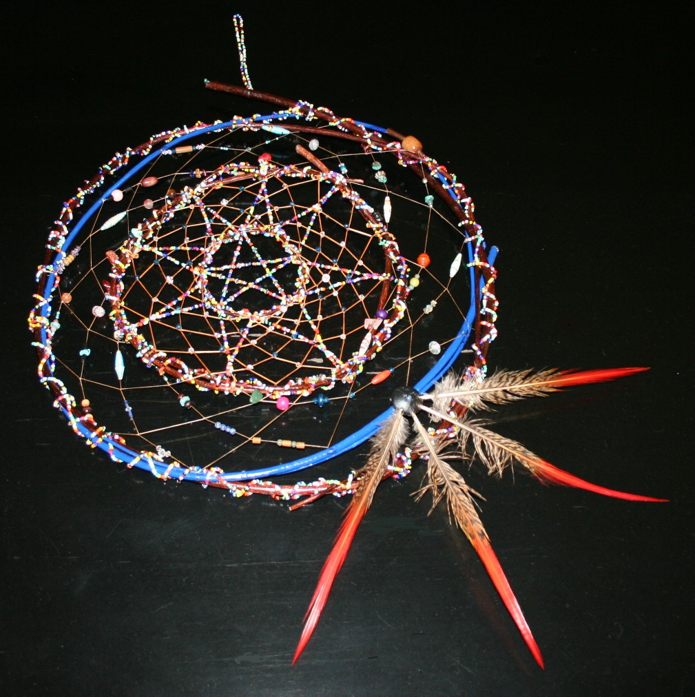 summer solstice dreamcatcher by john pete with four hoops, beaded star and bead embellishments, with colorful feathers