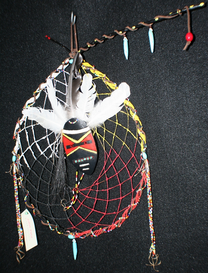 medicine man dreamcatcher by john pete with groud mask and beads, dyed sand, turquoise and feather accents